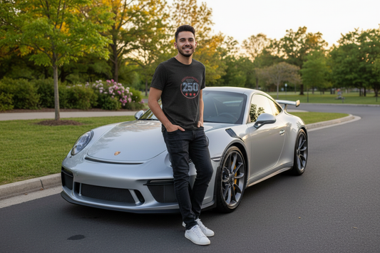 Model standing next to a Porsche wearing the America 250 Unisex T-shirt